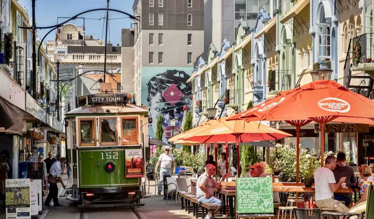 A historic tram cruising down a narrow street in sunny Christchurch, New Zealand