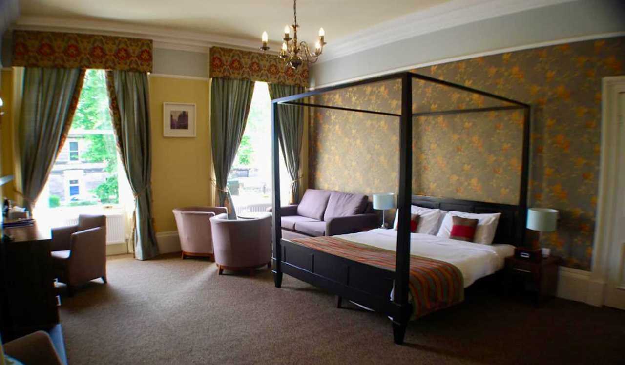 A boutique hotel room with a large four-poster bed in Edinburgh, Scotland