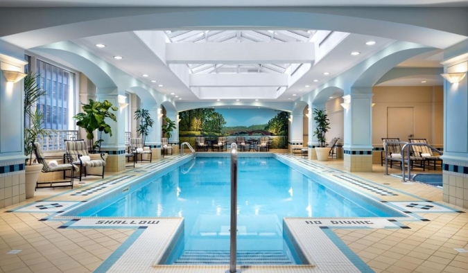 An indoor swimming pool in a glass atrium at the Fairmont Royal York Hotel in Toronto, Canada