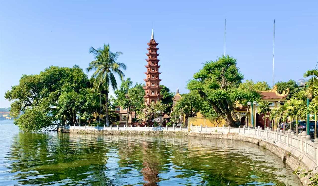 A sunny day in Hanoi, Vietnam near the lake with a historic pagoda in the background