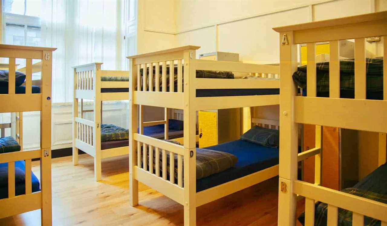 A spacious and bright dorm room with lots of wooden bunk beds at Edinburgh Backpackers in Scotland