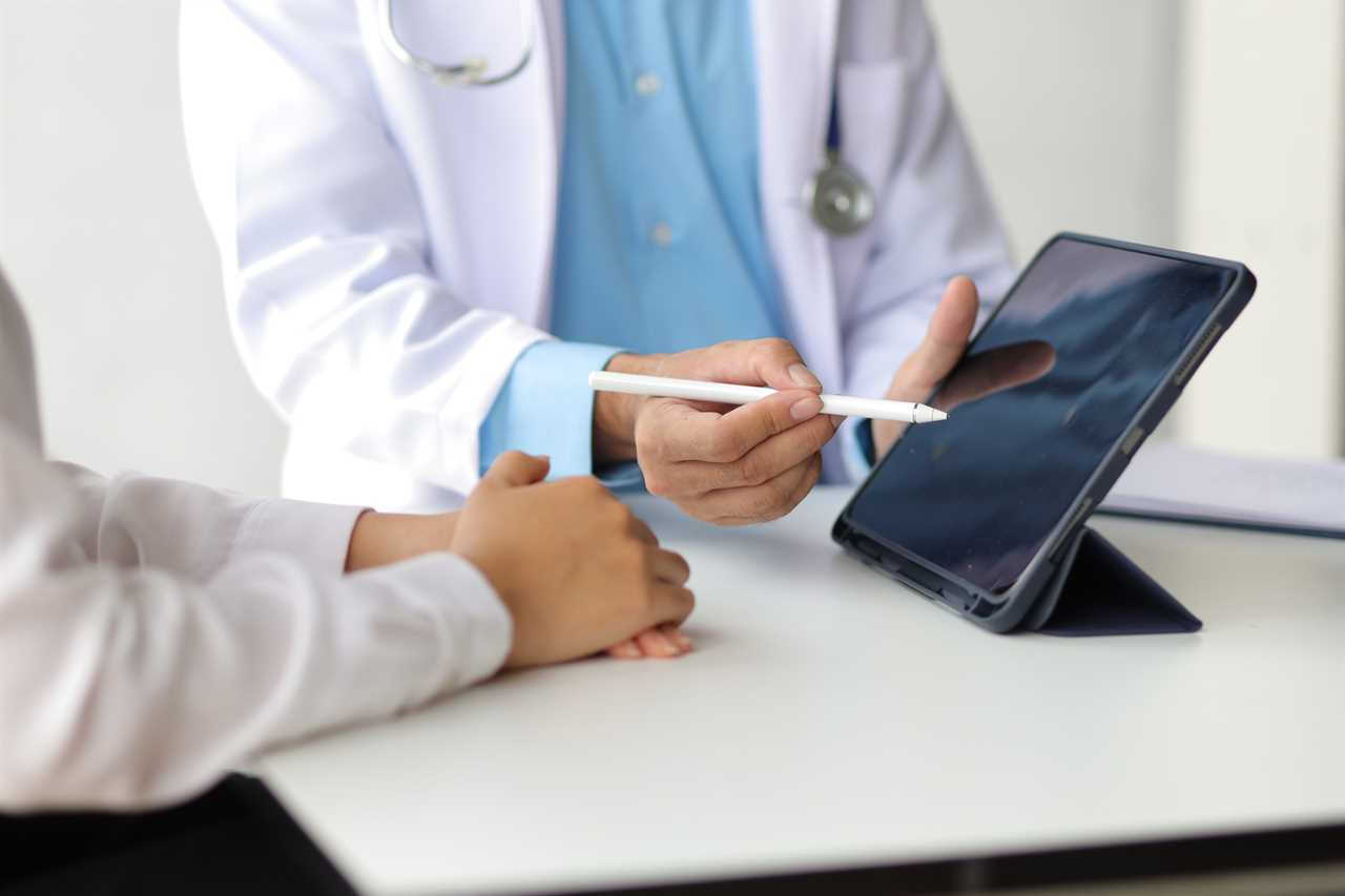 Doctor showing a patient some information on a digital tablet. Health examination and treatment of disease.