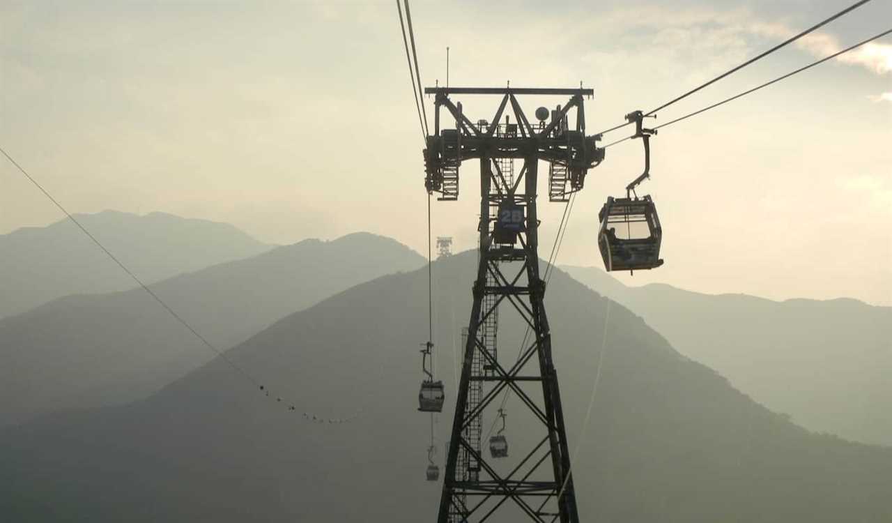 Nomadic Matt riding the cable car in Hong Kong on a smoggy day with low visibility