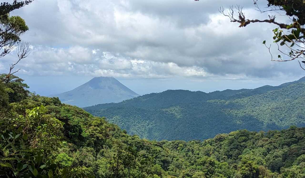 Arenal volcano as seen through the trees in La Fortuna, Costa Rica