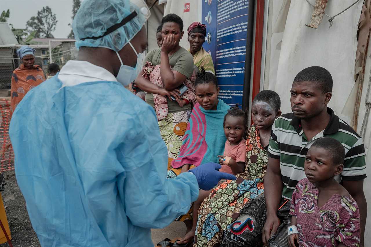 Patients listen to a doctor outside the consultation room of the Mpox treatment centre at Nyiragongo General Referral Hospital, north of Goma on Aug. 17, 2024.