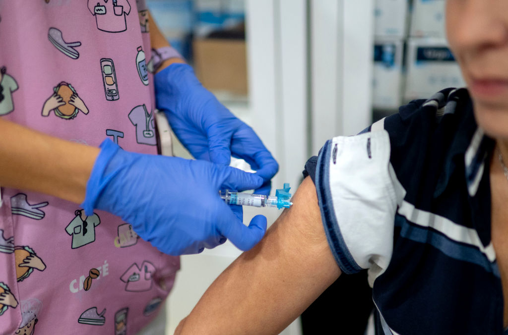 A woman receives a flu vaccine.