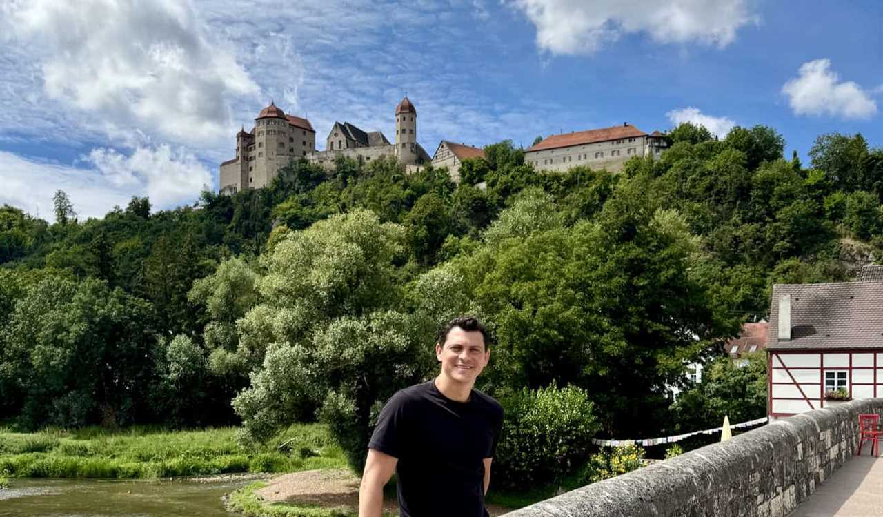 Nomadic Matt in Bavaria in Germany front of a castle