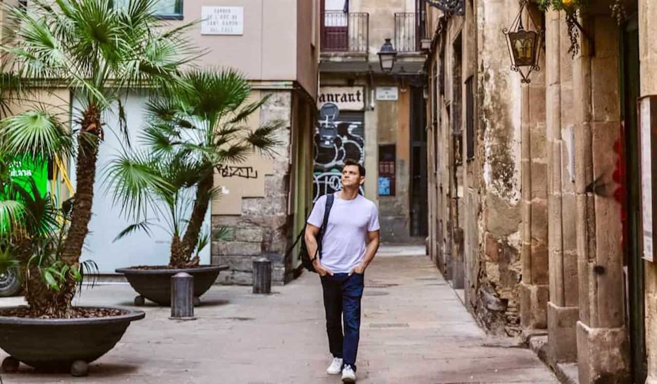 Nomadic Matt exploring the winding, narrow streets of Barcelona