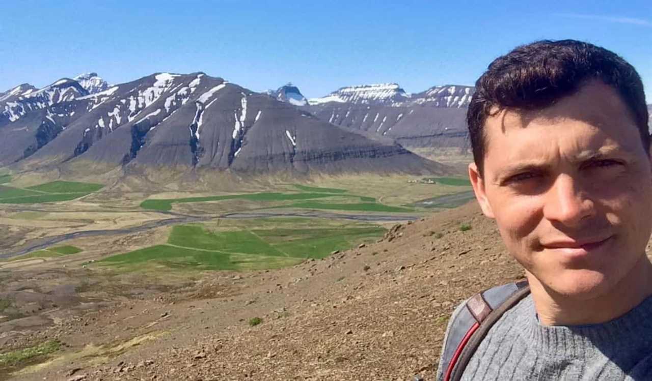 Nomadic Matt hiking in Iceland while hitchhiking around