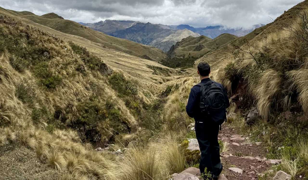 Nomadic Matt looking out over the sparse Sacred Valley in Peru