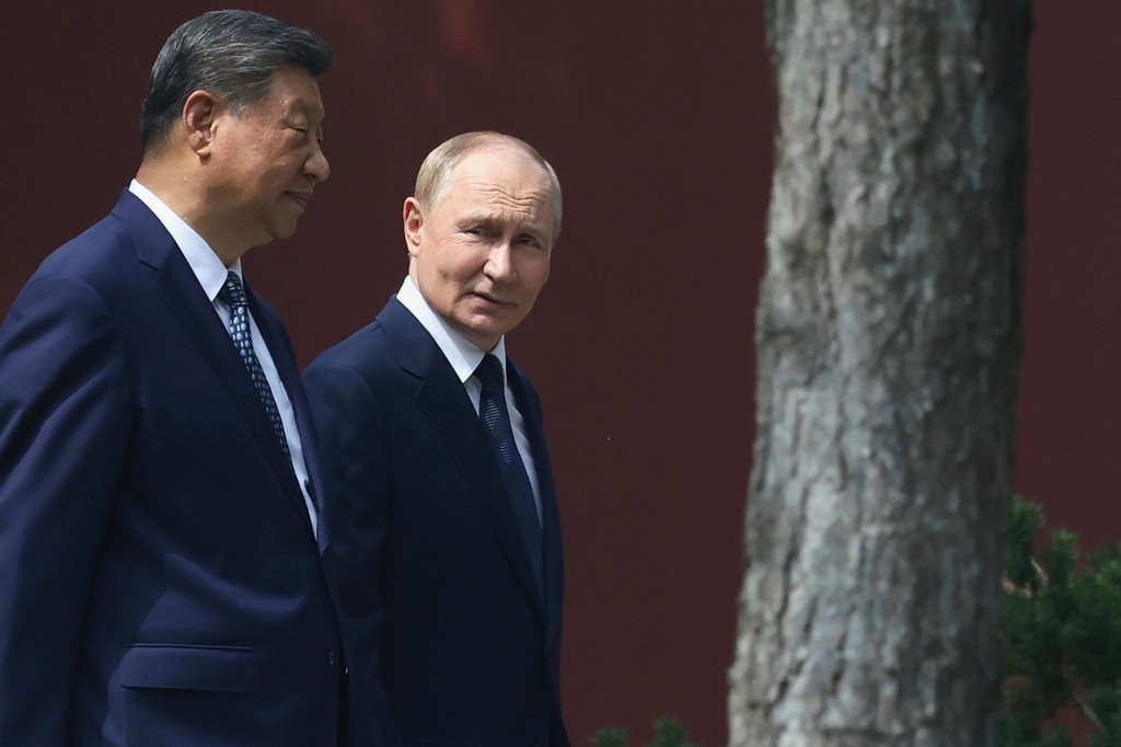 Russian President Vladimir Putin, right, speaks with Chinese President Xi Jinping during a walk at the Zhongnanhai leadership compound in Beijing, China, Sept. 2, 2025.