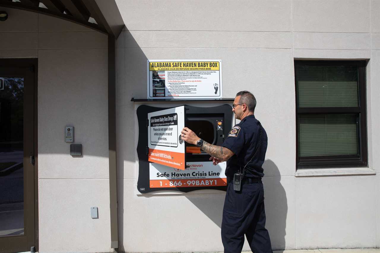 Engine 12 Captain Mike Allen opens the door to a Safe Haven Baby Box at a Mobile Fire Station No. 12 in Mobile Alabama on June 9th, 2025.