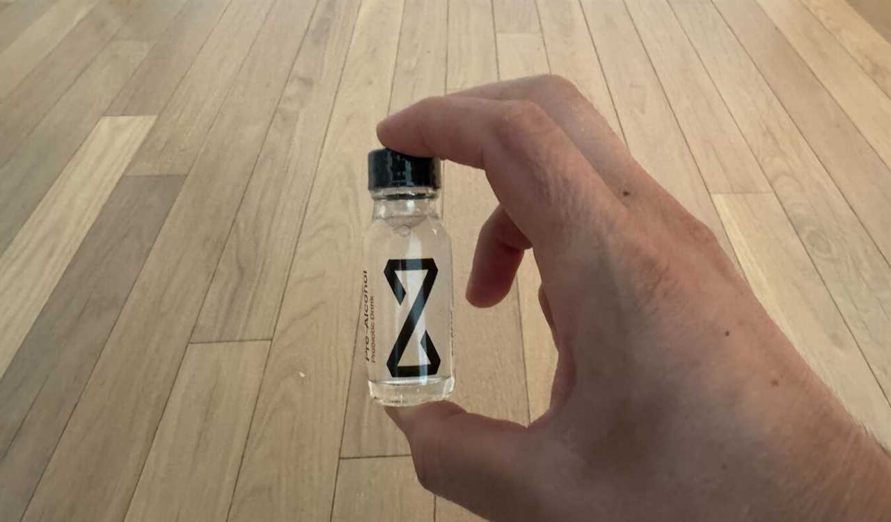 Nomadic Matt holding a small bottle of Zbiotics