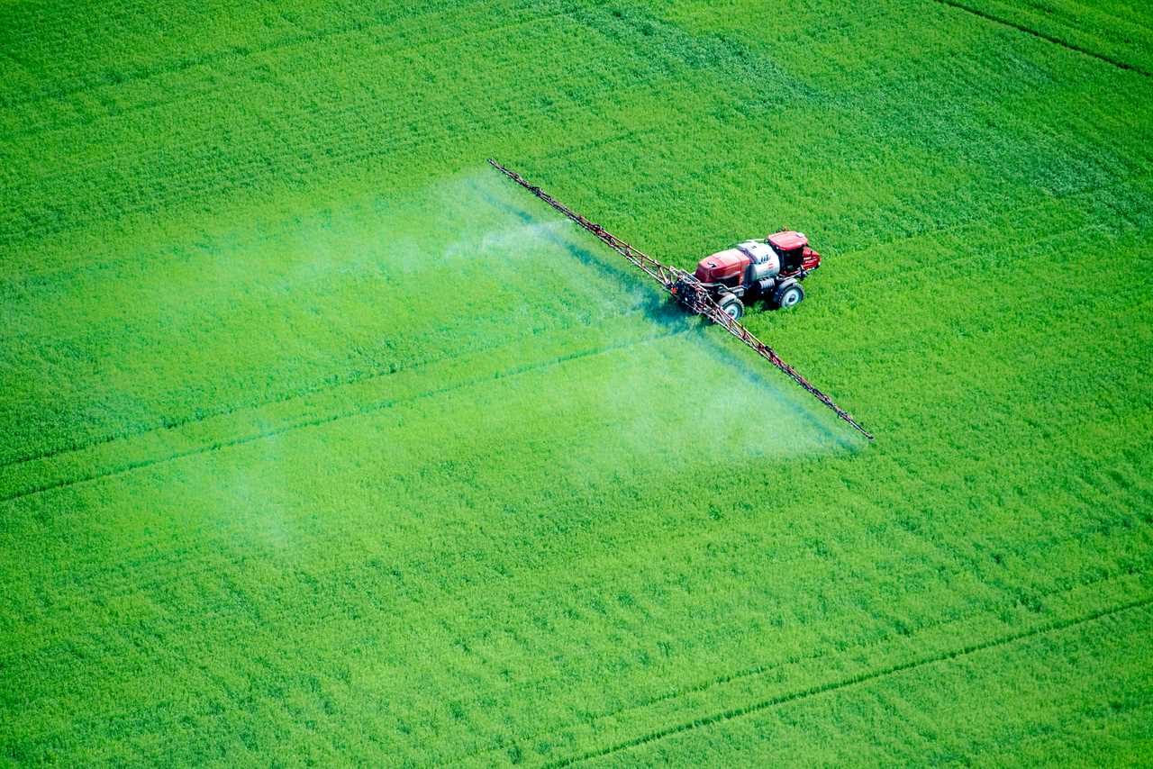 Aerial of spray application in green agricultural field on the eastern shore of Maryland, USA